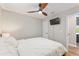 Bedroom featuring a ceiling fan, TV, and access to a screened-in porch at 754 Se 167Th Court Rd, Silver Springs, FL 34488