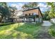 Inviting exterior view of a two-story home with a covered patio and a spacious lawn at 754 Se 167Th Court Rd, Silver Springs, FL 34488