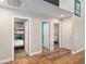 Hallway with access to multiple bedrooms, featuring wood-look floors at 754 Se 167Th Court Rd, Silver Springs, FL 34488