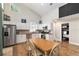 Modern kitchen with wood floors, stainless-steel appliances and light cabinets, with access to bedroom at 754 Se 167Th Court Rd, Silver Springs, FL 34488