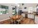 Kitchen and dining area featuring wood floors, lake view and stainless-steel appliances at 754 Se 167Th Court Rd, Silver Springs, FL 34488