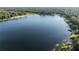 Open aerial view of a pristine lake, showcasing the clear water and the natural beauty of the surrounding area at 754 Se 167Th Court Rd, Silver Springs, FL 34488