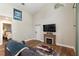 Living room features a decorative fireplace, wood floors, and a high ceiling at 754 Se 167Th Court Rd, Silver Springs, FL 34488
