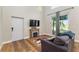 Cozy living room with wood floors, decorative fireplace, high ceiling and sliding glass doors at 754 Se 167Th Court Rd, Silver Springs, FL 34488