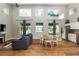 Spacious living room featuring hardwood floors, large windows with lake views, and a dining area at 754 Se 167Th Court Rd, Silver Springs, FL 34488