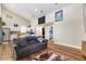 Open-concept living room and kitchen with wood floors, modern decor and easy access to bathroom at 754 Se 167Th Court Rd, Silver Springs, FL 34488