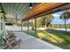 Relaxing covered patio with seating area overlooking the lake at 754 Se 167Th Court Rd, Silver Springs, FL 34488