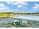 Scenic view of the lake with lounge chairs for relaxation at 754 Se 167Th Court Rd, Silver Springs, FL 34488