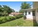 Beautiful backyard with lush green grass, neatly trimmed bushes, and a glimpse of the house's exterior at 8524 Sw 90Th Ln # B, Ocala, FL 34481