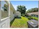 A view of the backyard with green grass, plants, and a peek at the neighbor's house at 8524 Sw 90Th Ln # B, Ocala, FL 34481