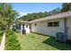 Lush backyard with a well-maintained lawn, green shrubbery, and a view of the house's exterior at 8524 Sw 90Th Ln # B, Ocala, FL 34481