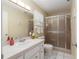 Bathroom with a glass-enclosed shower, white tile flooring, and a neutral color scheme at 8524 Sw 90Th Ln # B, Ocala, FL 34481