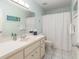 Well-lit bathroom featuring a white vanity, toilet, tub, and shower with tile flooring at 8524 Sw 90Th Ln # B, Ocala, FL 34481