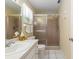 Bathroom featuring a glass-enclosed shower, neutral color scheme, and white tile flooring at 8524 Sw 90Th Ln # B, Ocala, FL 34481
