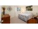 Cozy bedroom with a queen-sized bed, stylish linens, and a decorative art piece above the bed at 8524 Sw 90Th Ln # B, Ocala, FL 34481