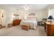 Bedroom with neutral colored walls and furnishings, a king-sized bed, and plenty of light at 8524 Sw 90Th Ln # B, Ocala, FL 34481