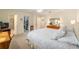 Bright bedroom with king bed, dresser, work desk, and access to ensuite bathroom and walk-in closet at 8524 Sw 90Th Ln # B, Ocala, FL 34481