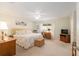 Spacious bedroom with a king-sized bed, desk, and sitting area; neutral tones and ample natural light at 8524 Sw 90Th Ln # B, Ocala, FL 34481