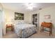 Comfortable bedroom featuring a bed, ceiling fan, and closet with a floral art piece on the wall at 8524 Sw 90Th Ln # B, Ocala, FL 34481