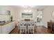 Dining room features a modern chandelier, sideboard and seating for six guests at 8524 Sw 90Th Ln # B, Ocala, FL 34481