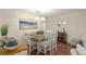 Bright dining area with modern lighting, seating for six, and adjacent living spaces at 8524 Sw 90Th Ln # B, Ocala, FL 34481