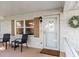 Front entrance to home with brick facade, brown shutters, wreath and seating area at 8524 Sw 90Th Ln # B, Ocala, FL 34481