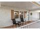Cozy front porch furnished with seating, framed by white brick and accented by brown shutters and a wreath at 8524 Sw 90Th Ln # B, Ocala, FL 34481