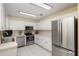 Well-lit kitchen features stainless steel appliances and white cabinetry at 8524 Sw 90Th Ln # B, Ocala, FL 34481