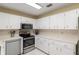 Well-lit kitchen featuring stainless steel appliances, white cabinetry, and ample counter space at 8524 Sw 90Th Ln # B, Ocala, FL 34481