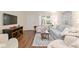Comfortable living room with wood floors, light-colored furnishings, and a large television at 8524 Sw 90Th Ln # B, Ocala, FL 34481