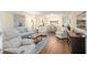 Open-concept living room with lots of seating, neutral paint, and wood floors at 8524 Sw 90Th Ln # B, Ocala, FL 34481