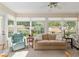 Inviting sunroom with large windows, a ceiling fan, and comfortable seating area at 8524 Sw 90Th Ln # B, Ocala, FL 34481