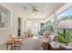 Bright sunroom featuring large windows, comfortable seating, and a ceiling fan at 8524 Sw 90Th Ln # B, Ocala, FL 34481
