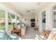Inviting sunroom featuring large windows, plush seating, and a ceiling fan, perfect for relaxation at 8524 Sw 90Th Ln # B, Ocala, FL 34481