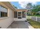 Backyard view showcasing a screened-in porch with a concrete patio and a white picket fence at 8681 Sw 93Rd Pl # B, Ocala, FL 34481