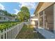 Landscaped backyard featuring a white picket fence, lawn, and screened-in porch at 8681 Sw 93Rd Pl # B, Ocala, FL 34481