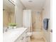 Well-lit bathroom featuring a white vanity with marble countertop and a tiled shower/tub at 8681 Sw 93Rd Pl # B, Ocala, FL 34481
