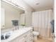 Bright bathroom featuring a marble countertop vanity, mirror, and neutral shower curtain at 8681 Sw 93Rd Pl # B, Ocala, FL 34481