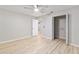 Spacious bedroom featuring a ceiling fan, closet, light floors, and neutral walls at 8681 Sw 93Rd Pl # B, Ocala, FL 34481