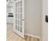Bright hallway featuring a white french door leading to the kitchen with light wood flooring at 8681 Sw 93Rd Pl # B, Ocala, FL 34481