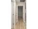 Hallway with laminate flooring, with multiple doorways at 8681 Sw 93Rd Pl # B, Ocala, FL 34481