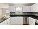 Beautiful kitchen featuring white cabinets, black countertops and stainless steel appliances and a window at 8681 Sw 93Rd Pl # B, Ocala, FL 34481