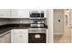 Modern kitchen with stainless steel appliances, light wood floors, and white cabinets offering ample storage at 8681 Sw 93Rd Pl # B, Ocala, FL 34481
