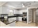 Renovated kitchen featuring granite countertops, stainless steel appliances, and white cabinets at 8681 Sw 93Rd Pl # B, Ocala, FL 34481