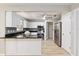 Updated kitchen with granite counters, white cabinetry, stainless appliances, and light wood flooring at 8681 Sw 93Rd Pl # B, Ocala, FL 34481