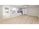 Open living room with new laminate flooring and easy access to the kitchen at 8681 Sw 93Rd Pl # B, Ocala, FL 34481
