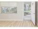 Bright living room with light wood flooring, a window and an open door at 8681 Sw 93Rd Pl # B, Ocala, FL 34481
