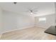 Open-concept living room with light wood floors and a modern ceiling fan at 8681 Sw 93Rd Pl # B, Ocala, FL 34481