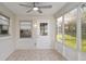Bright sunroom features tile flooring, large windows, and a ceiling fan at 8681 Sw 93Rd Pl # B, Ocala, FL 34481