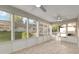 Inviting sunroom with tile flooring, large windows, ceiling fans, and an exterior view at 8681 Sw 93Rd Pl # B, Ocala, FL 34481